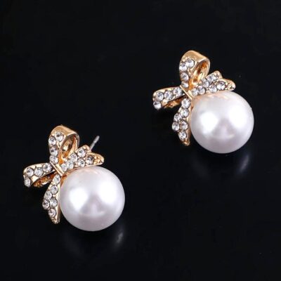 Gleaming Bow Bold Pearl Stud Earrings